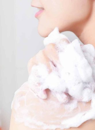 Woman taking a shower enjoying with foam bath.